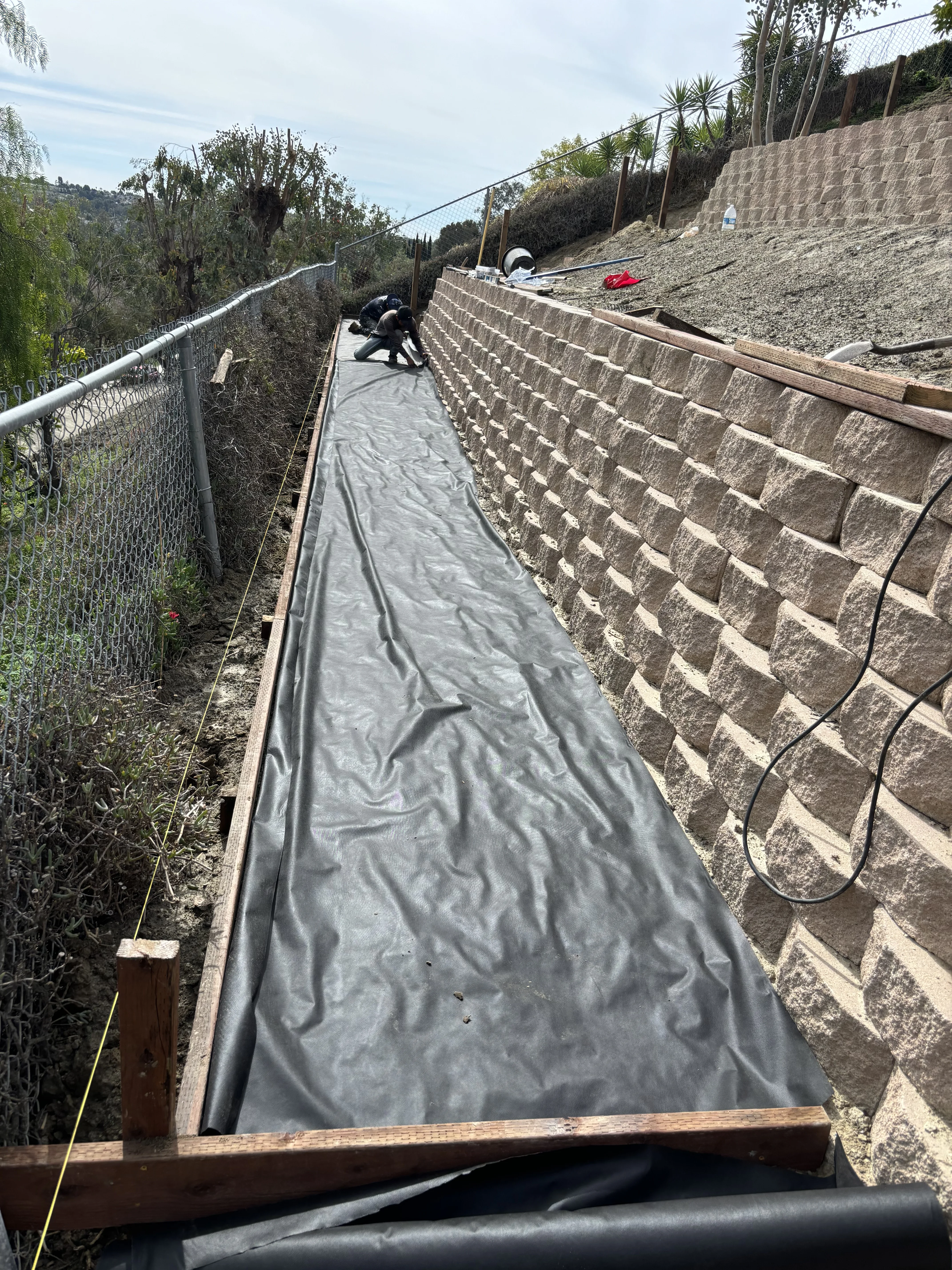 After photo of engineered brick retaining wall on slope in Rancho Mission Viejo, CA by Lobato Landscaping